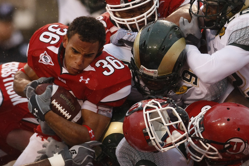 Chris Detrick  |  The Salt Lake Tribune 
Utah Utes running back Eddie Wide #36 has his helmet knocked off by Colorado State Rams cornerback Ivory Herd #35 and Colorado State Rams defensive end C.J. James #9 during the first half of the game at Rice-Eccles Stadium Saturday October 23, 2010.  The Utes are winning the game 24-6.