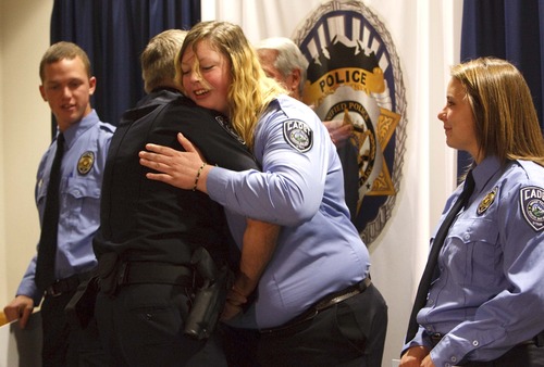 Leah Hogsten  |  The Salt Lake Tribune
Jessica Anglesey (center) gets a hug from Salt Lake County Sheriff Jim Winder as he congratulates the cadets including McQuade Allen (left) and Megan Kelsch (right) and three others not pictured.  The Salt Lake Honorary Colonels and Salt Lake County Sheriff Jim Winder awarded scholarship checks to six Unified Police Department youth cadets to help them pay for their college or POST training, Tuesday, July 30,2013.
