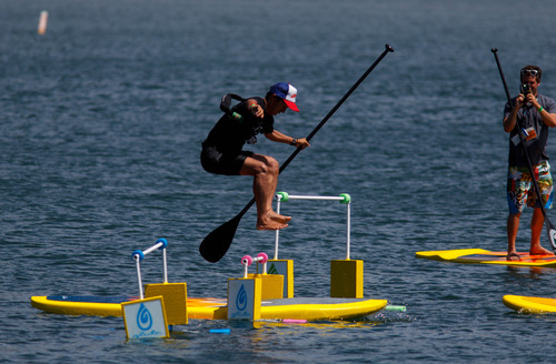 Trent Nelson  |  The Salt Lake Tribune
A man makes a jump on a paddleboard as Outdoor Retailer Summer Market convention-goers try out personal watercraft at Pineview Reservoir, Tuesday July 30, 2013.