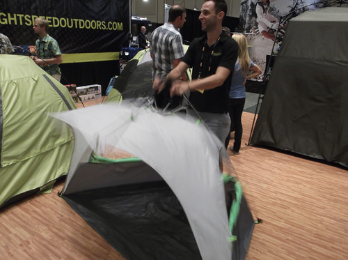 Sean P. Means  |  The Salt Lake Tribune
At the Outdoor Retailers Summer Market in the Salt Palace, Eli Resnik from Lightspeed Outdoors of San Diego demonstrated -- over and over again -- how fast the Bahia Quick Draw mini-shelter can open and close. Oddly enough, he didn't seem bored by this.