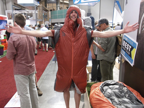 Sean P. Means  |  The Salt Lake Tribune
Ever been camping and needed to get up at 2 a.m. -- and didn't want to leave your warm sleeping bag? Mike Newlands of Boulder, Colo., happily demonstrates Sierra Designs' new Mobile Mummy, a sleeping bag with a zipper that allows the user to stick one's legs out to walk, and armholes for quick access.
