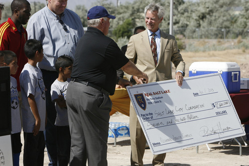 Francisco Kjolseth  |  The Salt Lake Tribune
Mayor Ralph Becker, right, is all smiles after receiving a ceremonial check from Real Salt Lake (RSL) owner Dell Loy Hansen to re-start the construction on the city's voter-approved Regional Athletic Complex (RAC) with an RSL's gift of $7.5 million to help complete the project. The soccer complex property, near 2100 North Rose Park Lane, will have 16 new fields and is expected to be completed in the summer of 2015.