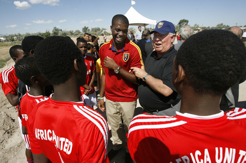 Francisco Kjolseth  |  The Salt Lake Tribune
Real Salt Lake (RSL) owner Dell Loy Hansen, center left, jokes around with RSL defender Kwame Watson-Siriboe as they meet members of the Africa United youth team following an event to recognize both the official re-start of construction on the city's voter-approved Regional Athletic Complex (RAC) and RSL's gift of $7.5 million to help complete the project near 2100 North Rose Park Lane on Thursday, Aug. 1, 2013.