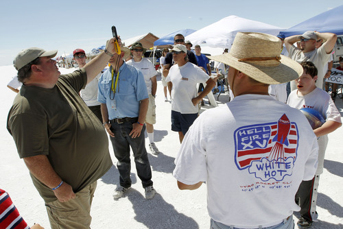 Al Hartmann  |  The Salt Lake Tribune
Participants in Hellfire 18 gather for a safety meeting and measure the wind speed before launching their first rockets over four days on the Bonneville Salt Flats.
