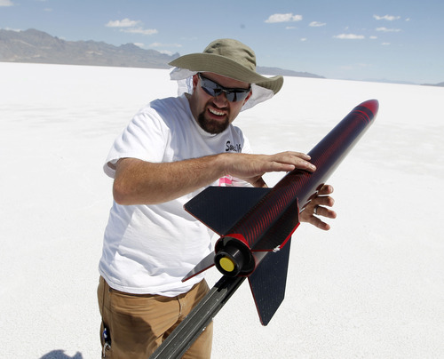 Al Hartmann  |  The Salt Lake Tribune
Ken Adams from Logan sets up his H-400 rocket on the Bonneville Salt Flats Thursday morning for Hellfire 18, a Utah Rocket Club event in which amateur rocket enthusiasts launch a variety of model rockets up to three miles in the air.
