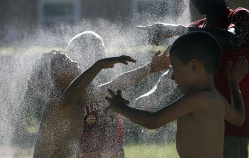 Francisco Kjolseth  |  The Salt Lake Tribune
Rose Park kids cool off in the summer heat as neighbors come together for a neighborhood barbecue along Lafayette Drive recently to enjoy each other's company.