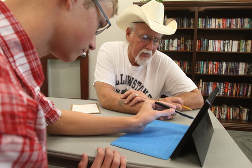Rick Egan  |  The Salt Lake Tribune 
Josh Pulsipher helps 70-year-old Sam Burton with his tablet at the North Davis Senior Activity Center in Clearfield on Friday. Pulsipher helps seniors with their electronic devices, such as iPads and cellphones, and shows them how to use Twitter and Facebook.