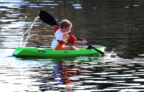 Rick Egan  | The Salt Lake Tribune 

Eight-year-old Emily Harvey, Bountiful, paddles a canoe in Farmington Pond, Wednesday, July 31, 2013.