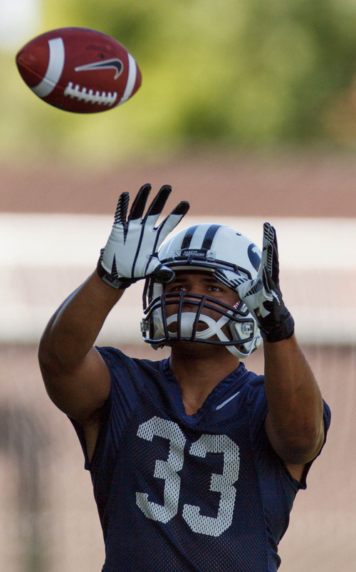 Trent Nelson  |  The Salt Lake Tribune
Paul Lasike warming up at BYU football practice in Provo Saturday August 3, 2013.