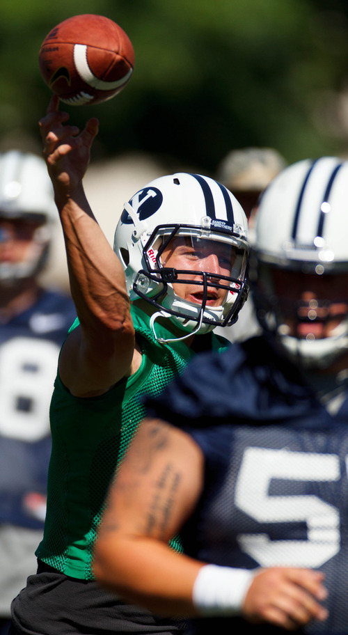 Trent Nelson  |  The Salt Lake Tribune
Taysom Hill throws the ball at BYU football practice in Provo Saturday August 3, 2013.