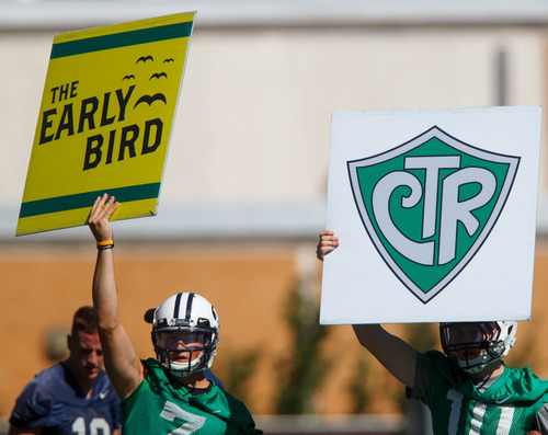 Trent Nelson  |  The Salt Lake Tribune
Christian Stewart and Billy Green hold up play cards at BYU football practice in Provo Saturday August 3, 2013.