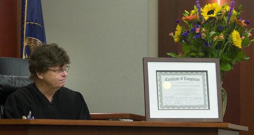 Paul Fraughton  |   Salt Lake Tribune
Third District Court  Judge, Judith Atherton glances over at the certificate of completion presented to  her by mental health team members and clients of the Mental Health Court. Monday, July 29, 2013