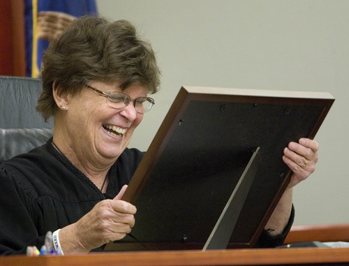 Paul Fraughton  |   Salt Lake Tribune
Third District Court  Judge, Judith Atherton reads the certificate of completion presented to  her by mental health team members and clients of the Mental Health Court. Monday, July 29, 2013