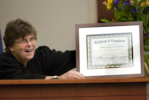 Paul Fraughton  |   Salt Lake Tribune
Third District Court  Judge, Judith Atherton holds her own  certificate of completion presented to  her by mental health team members and clients of the Mental Health Court. Judge Atherton  is retiring at the end of the month after almost two decades on the bench.  Monday, July 29, 2013