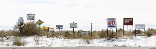 Trent Nelson  |  Tribune file photo
Signs point to extraction operations in the oil fields of the Uinta Basin southeast of Vernal in 2012. A new report says much more methane gas leaks from the basin's oil and gas operations than previously believed.