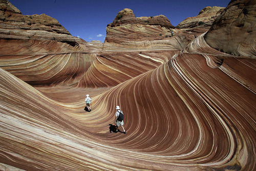 Tribune file photo
Hikers among the rock formations at The Wave in the Coyote Buttes area of the Paria Canyon-Vermillion Cliffs Wilderness on the Utah/Arizona border in September 2007.
