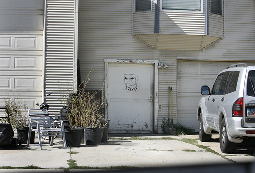 Scott Sommerdorf   |  The Salt Lake Tribune
The garage at the home near 450 E. 10400 South in Sandy, Friday, August 2, 2013. The door at the right has an image of a dog.