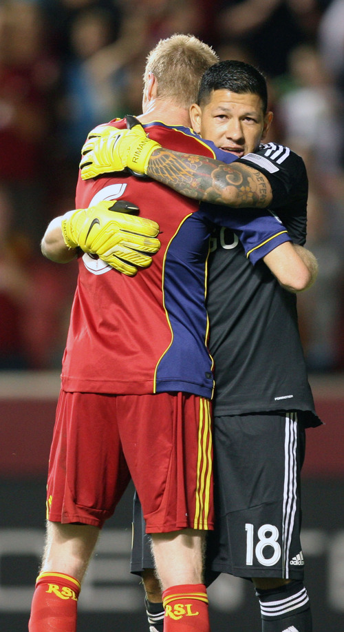 Steve Griffin | The Salt Lake Tribune

Real Salt Lake's Nick Rimando , right, hugs teammate Nat Borchers after RSL defeated Portland 2-1 advancing to the finals of the U.S. Open Cup at Rio Tinto Stadium in Sandy, Utah Wednesday August 7, 2013.
