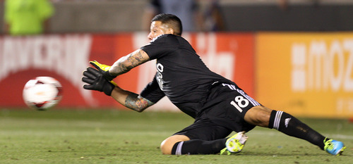 Steve Griffin | The Salt Lake Tribune

Real Salt Lake's Nick Rimando makes a diving stop on a Portland shot, unfortunately the ball rebounded right to a Portland player who headed the ball into the net for the Timbers only goal during second half action of the RSL vs. Portland U.S. Open Cup semifinals soccer match at Rio Tinto Stadium in Sandy, Utah Wednesday August 7, 2013.