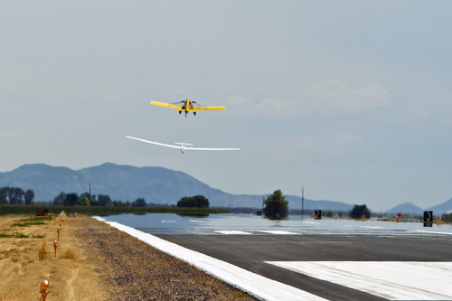 Chris Detrick  |  The Salt Lake Tribune
Dan Wrobel of Ogden is pulled by a tow plane to take off in his glider during the Nephi Glider Competition at the Nephi Airport Wednesday Aug. 7, 2013. About 40 pilots from around the country participated in the weeklong event.
