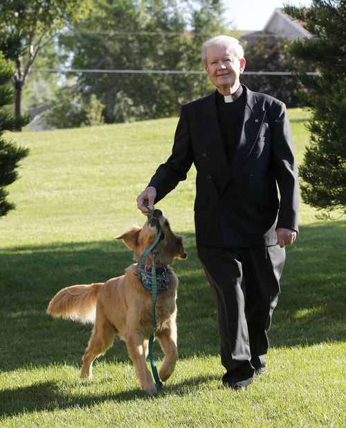 Al Hartmann  |  The Salt Lake Tribune
Monsignor Terence Moore plays with his dog Bailey on a walk.   The pastor of Saint John the Baptist Parish in Draper is retiring after serving 46 years in the Salt Lake City Diocese.