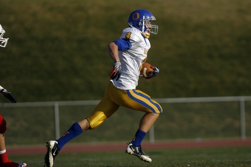 Chris Detrick  |  The Salt Lake Tribune
Orem's Cole Payne (4) runs for a touchdown against East High in October 2011.