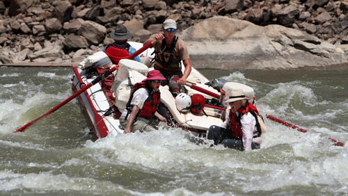 Francisco Kjolseth  |  The Salt Lake Tribune
Holiday River guide Julian Springer points the raft straight into a hole as Carol McWilliam and Bob Hollingsworth brace for impact while navigating the rapids of Cataract Canyon in July 2012.