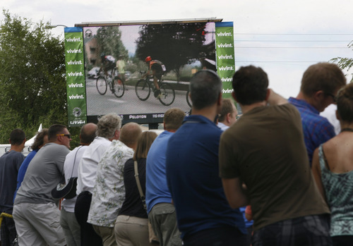 Scott Sommerdorf   |  The Salt Lake Tribune
Cycling fans near the start/finish line keep track of the race on a video screen during Stage 4 of the Tour of Utah, Friday, August 9, 2013.