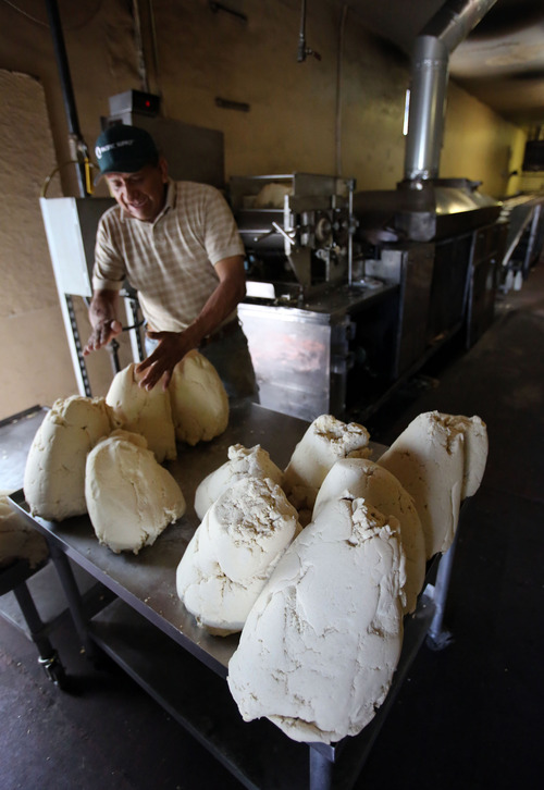 Francisco Kjolseth  |  The Salt Lake Tribune
José Antonio Aranda feeds corn masa into a machine that makes tortillas at the Acapulco Mexican market along Indiana on the west side of Salt Lake City. The market caters to many ethnic cultures in the area, and the tortillas are the biggest part of its business.