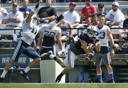 Scott Sommerdorf   |  The Salt Lake Tribune
BYU WR Kust Henderson dropped this pass under pressure from DB Dallin Leavitt during scrimmage at LaVell Edwards Stadium, Saturday, August 10, 2013.
