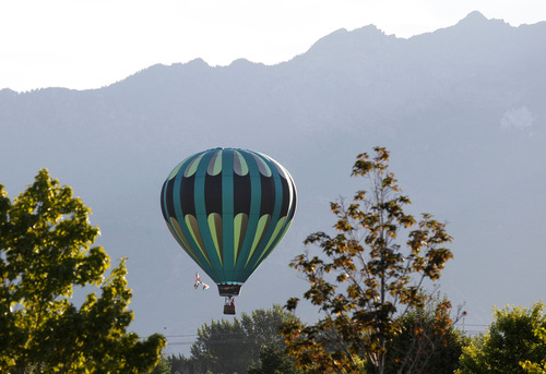 Al Hartmann  |  The Salt Lake Tribune
Hot air balloons rise from Storm Mountain Park in Sandy early Friday morning for the Sandy Balloon Festival.