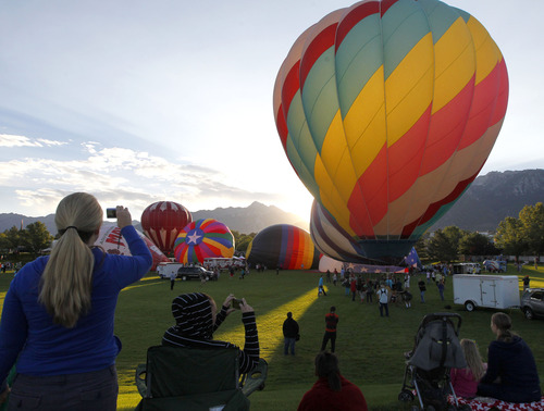 Al Hartmann  |  The Salt Lake Tribune
Hot air balloons rise from Storm Mountain Park in Sandy early Friday morning for the Sandy Balloon Festival.