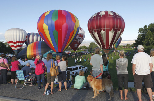 Al Hartmann  |  The Salt Lake Tribune
Hot air balloons rise from Storm Mountain Park in Sandy early Friday morning for the Sandy Balloon Festival.