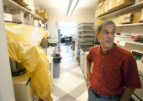 Steve Griffin | The Salt Lake Tribune

Because of leaking water pipes, Carl Thummel is forced to cover expensive lab equipment with plastic sheeting in one of his labs at the Eccles Human Genetics Building at the University of Utah in Salt Lake City Wednesday July 17, 2013.