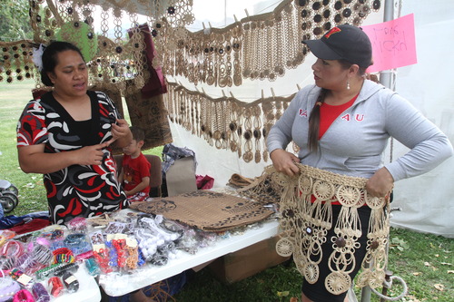 Rick Egan  |  The Salt Lake Tribune 
Vicky Love shows Tevila Gerber Lavew some of the authentic Kie kie's for sale at the National Tongan American Society's 16th Annual Friendly Island Festival at Fairmont Park in Sugar House on Saturday.