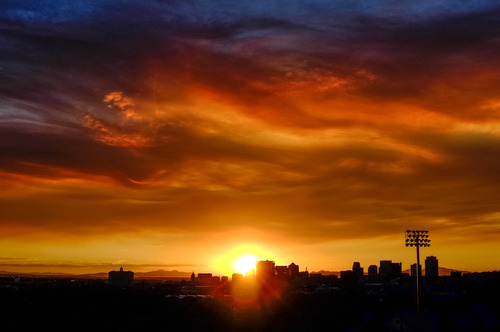 Trent Nelson  |  The Salt Lake Tribune
The sun sets over a smoky Salt Lake City skyline Sunday August 11, 2013.