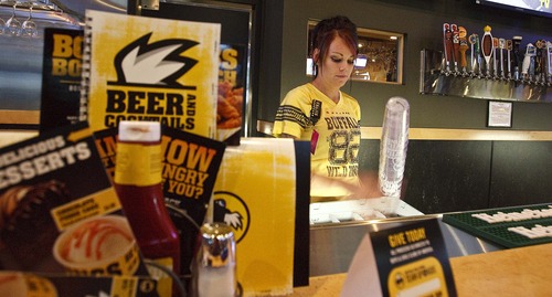 Leah Hogsten | The Salt Lake Tribune
Bartender Nicona Stadtmueller works at the front "bar" at Buffalo Wild Wings, Layton where beers and mixed drinks are poured in a room behind her, Thursday, August 8, 2013.  In 2012, Buffalo Wild Wings restaurant told liquor-control commissioners it would have to delay construction on its Layton store because the state had run out of liquor licenses. Since then, lawmakers have created more permits and now the chain has eight locations in Utah.