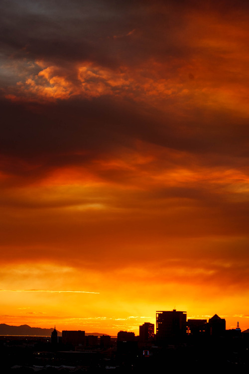 Trent Nelson  |  The Salt Lake Tribune
The sun sets over a smoky Salt Lake City skyline Sunday August 11, 2013.