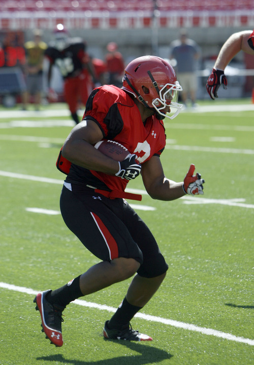 Francisco Kjolseth  |  The Salt Lake Tribune
Marcus Williams looks for an opening as the University of Utah's football team holds their first preseason scrimmage at the stadium on Tuesday, August 13, 2013.