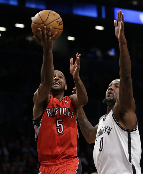 Toronto Raptors guard John Lucas (5) goes up for a layup with Brooklyn Nets forward Andray Blatche (0) defending in the second half of their NBA basketball game at the Barclays Center, Tuesday, Jan. 15, 2013 in New  York. (AP Photo/Kathy Willens)