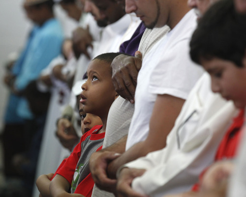 Al Hartmann  |  The Salt Lake Tribune
Utah Muslim fathers and sons pray at the Khadeeja Islamic Center in West Valley City on Thursday, Aug. 8, to celebrate the end of their monthlong fast for Ramadan.
