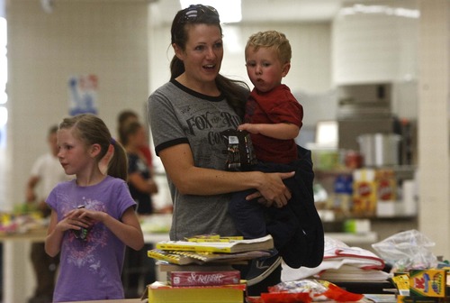 Leah Hogsten | The Salt Lake Tribune
Brittney Miller, her son Canyon, 3, daughter Emma, 8, (left) and daughter Ali, 5, (not pictured) spent the afternoon at the Red Cross shelter at the North Summit Middle School waiting word from Miller's husband whether their home was spared. The Miller's were backpacking in the Uinta Mountains when they received word that their subdivision was on fire. A wildfire in Summit County has forced an evacuation of a community and destroyed up to 15 homes as flames continued spreading Tuesday evening. The fire is across the road from Lake Rockport Estates, which runs adjacent to State Road 32 near hamlets of Coalville and Wanship. Residents there have been ordered to evacuateTuesday, August 13, 2013.
