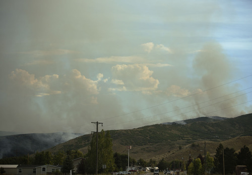 Lennie Mahler  |  The Salt Lake Tribune
Smoke rises from a wildfire near Rockport State Park as seen from the town of Wanship, Tuesday, Aug. 13, 2013.