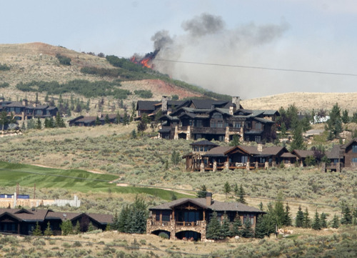Steve Griffin | The Salt Lake Tribune

Flames leap from a ridge line above the Promontory development as the Wanship 5 wildfire continues to burn Wednesday August 14, 2013.