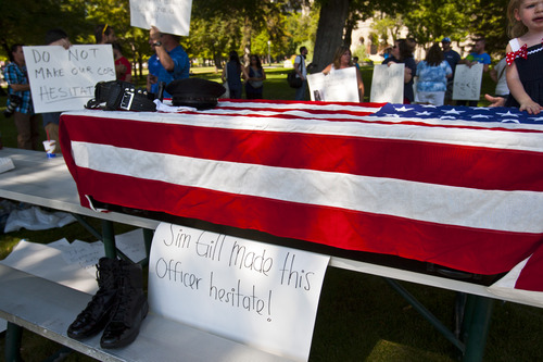 Chris Detrick  |  The Salt Lake Tribune
A casket draped in an American flag with the sign stating, 'Sim Gill made this officer hesitate!" during a rally to support police officers in their right to defend themselves "without fear of retribution from the Salt Lake County District Attorney" at the Salt Lake City and County Building Wednesday August 14, 2013.