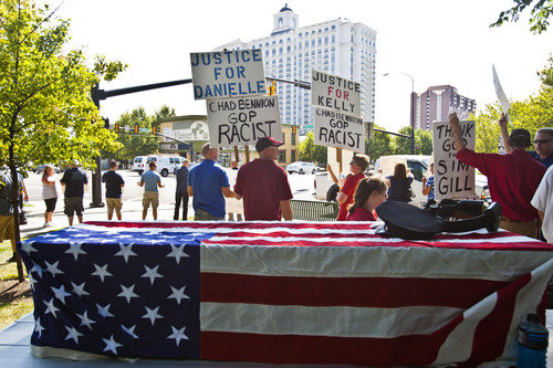 Chris Detrick  |  The Salt Lake Tribune
People hold signs during a rally at the Salt Lake City and County Building Wednesday August 14, 2013.