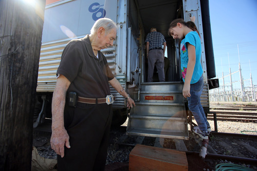 Francisco Kjolseth  |  The Salt Lake Tribune
Les Tippie, 84, who just retired following a 40-year run as the president of the Promontory Chapter of the National Railway Historical Society gently coaxes his great grandaughter Cassidy Mantas, 9, on to a safer step on the club's main attraction, the 1948 "Moonlight Dome" rail car.