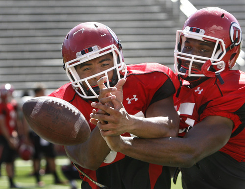 Scott Sommerdorf   |  The Salt Lake Tribune
Tight ends Siale Fakailoatonga, left and Greg Reese, right, fight for the ball in a drill during Utah football practice, Wednesday, August 14, 2013.