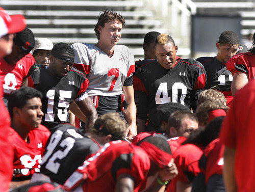 Scott Sommerdorf   |  The Salt Lake Tribune
DB Michael Walker, #15, QB Travis Wilson, #7, LB Jacoby Hale, #40, and other Utes listen to coach Whittingham after Utah football practice, Wednesday, August 14, 2013.