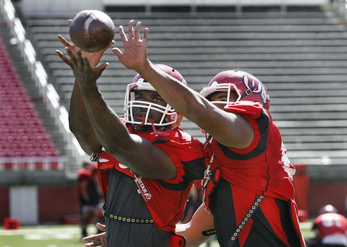 Scott Sommerdorf   |  The Salt Lake Tribune
Tight ends Siale Fakailoatonga, left and Greg Reese, right, fight for the ball in a drill during Utah football practice, Wednesday, August 14, 2013.